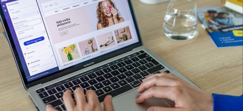 Hands typing on a laptop open on an online beauty shop