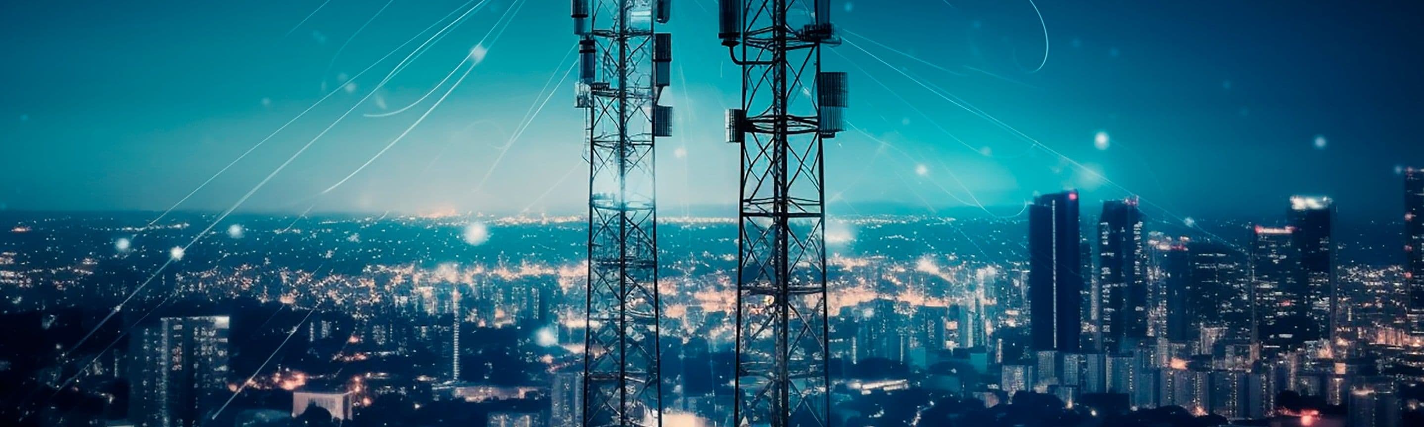 Two telecom towers against a city skyline at night, linked by points of light