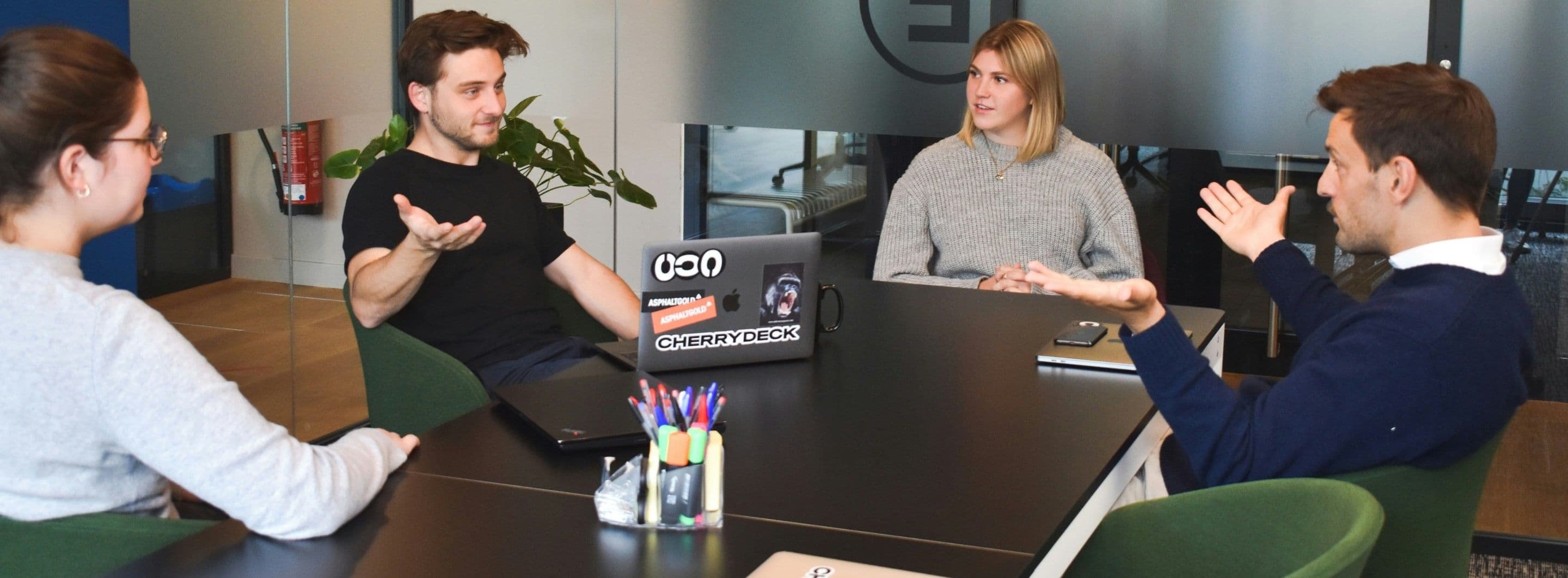 A team in conversation around a meeting table